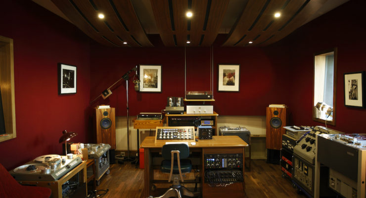 Professional record studio showing table, systems, lights