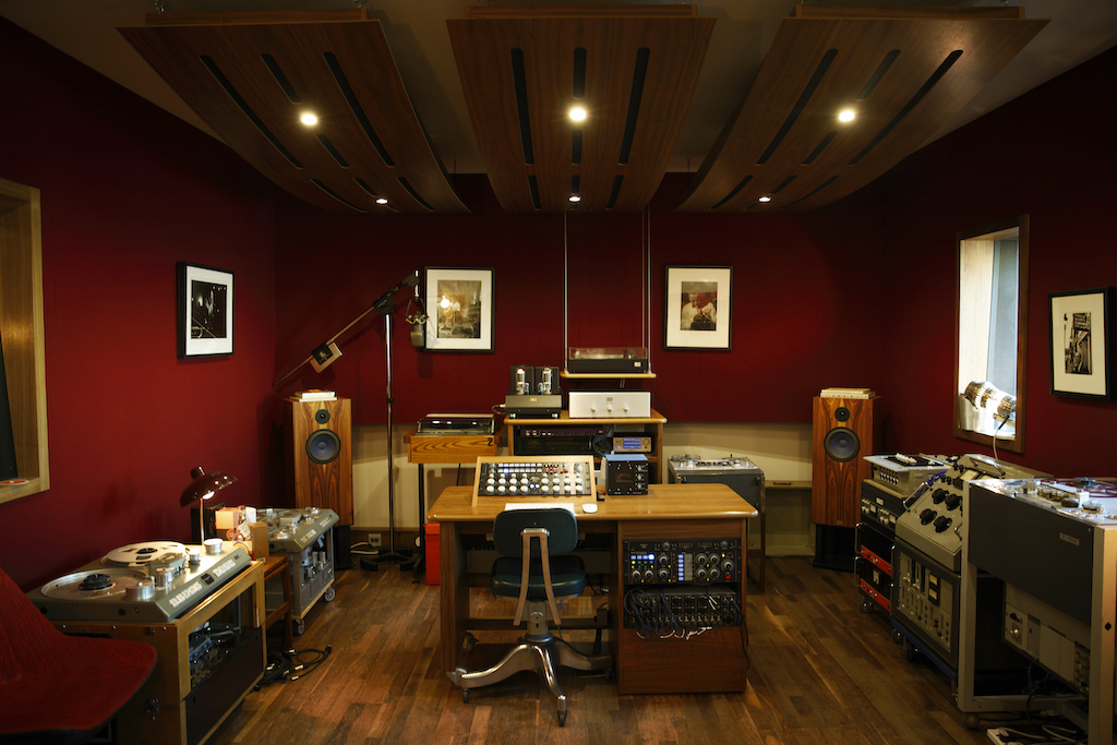 A professional record studio showing table, systems, and lights